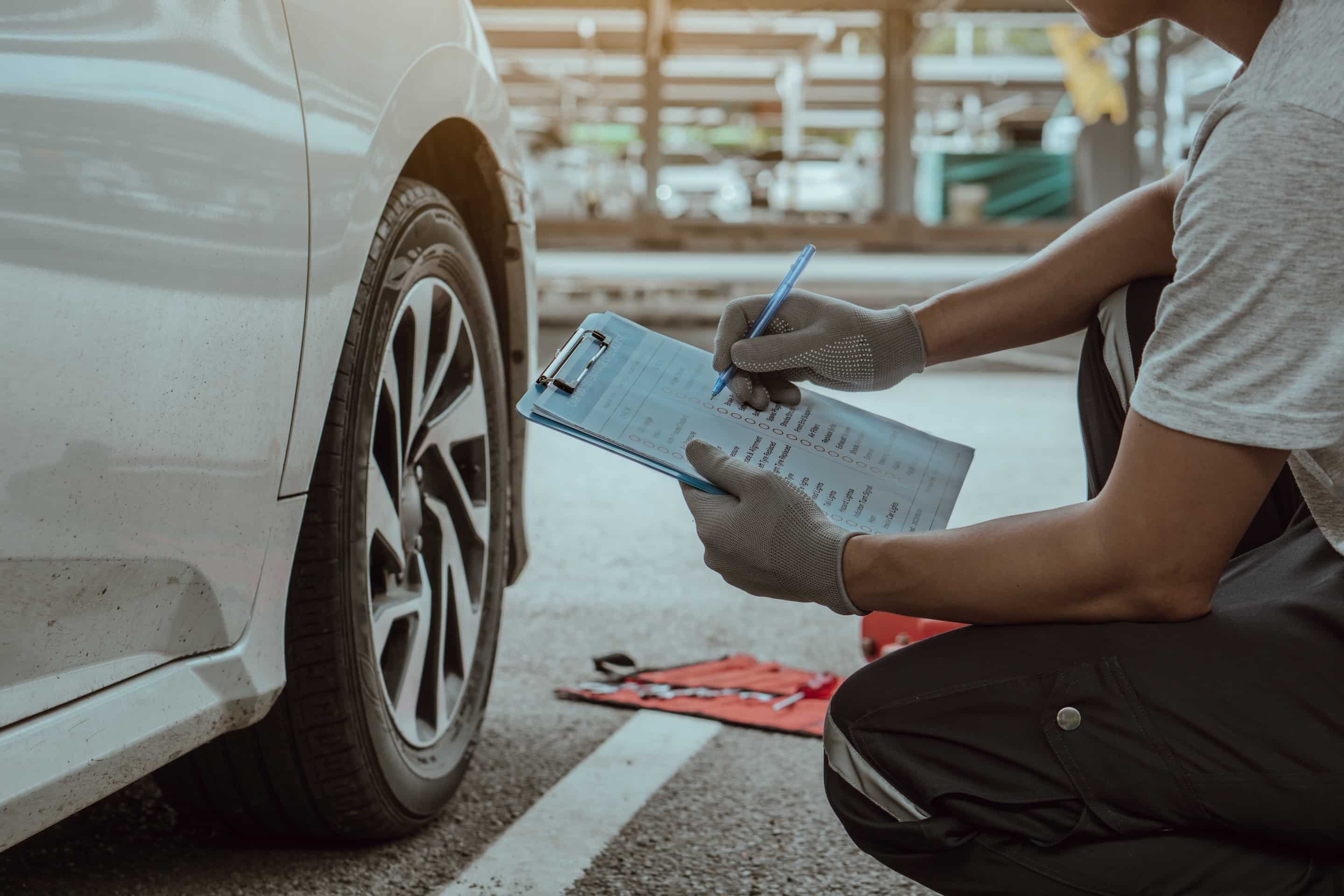 mechanic holding the clipboard to checking car whe 2026 03 13 01 54 16 utc